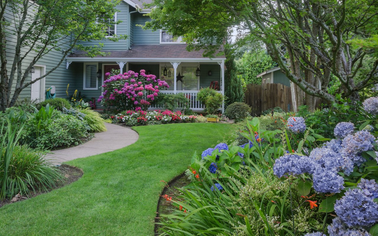 house with beautiful landscaping with trees and bushes and flowers - Professional Landscaping Utah