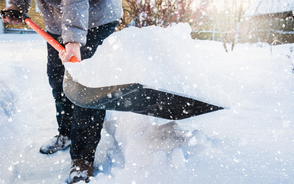 snow removal with shovel - professional landscaping Utah