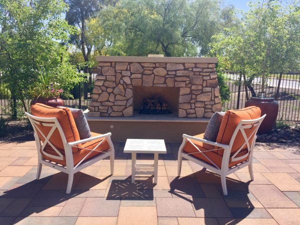 Outdoor fireplace and chairs on a patio